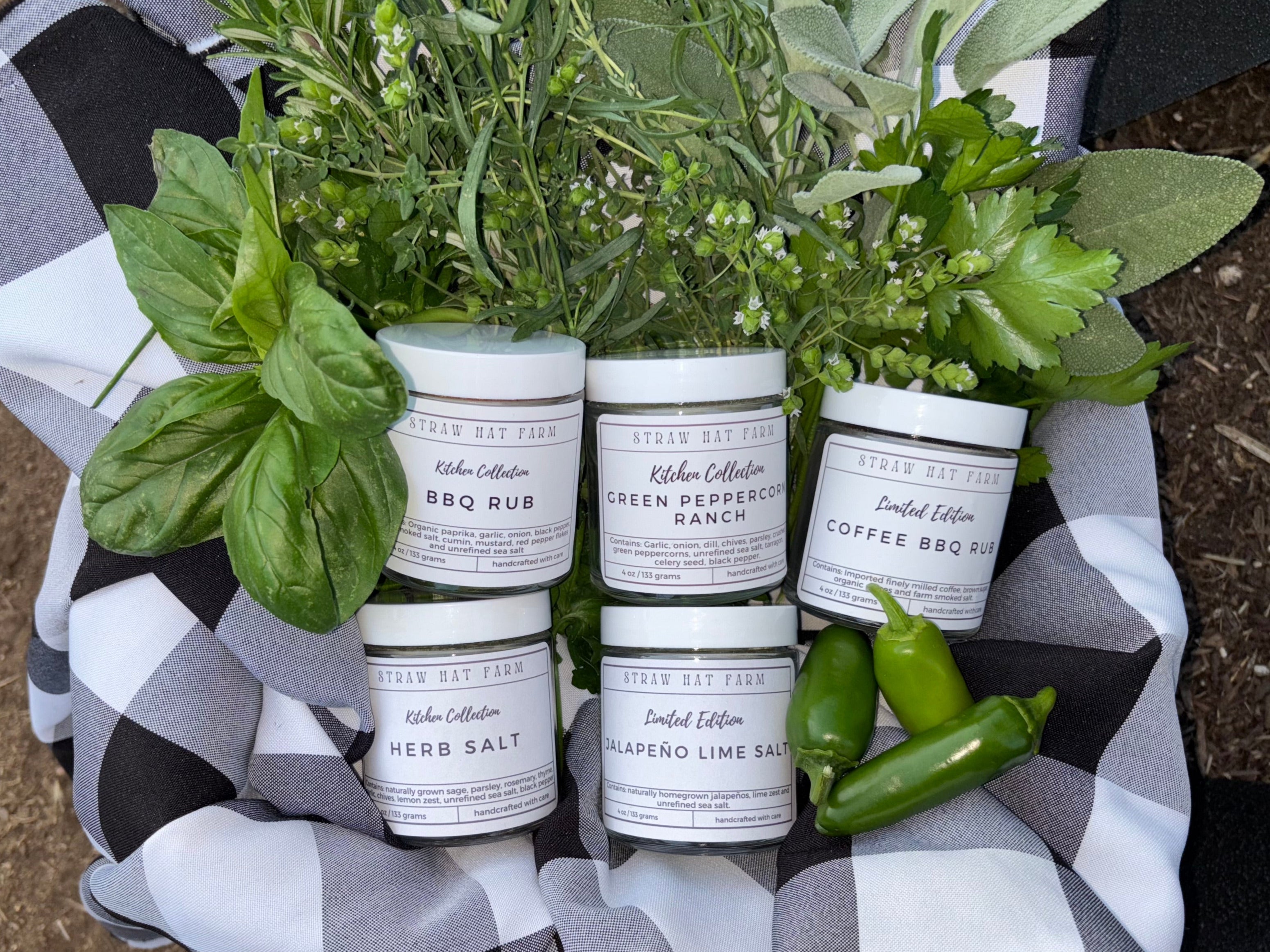 a basket of five seasoning blends surrounded by fresh herbs